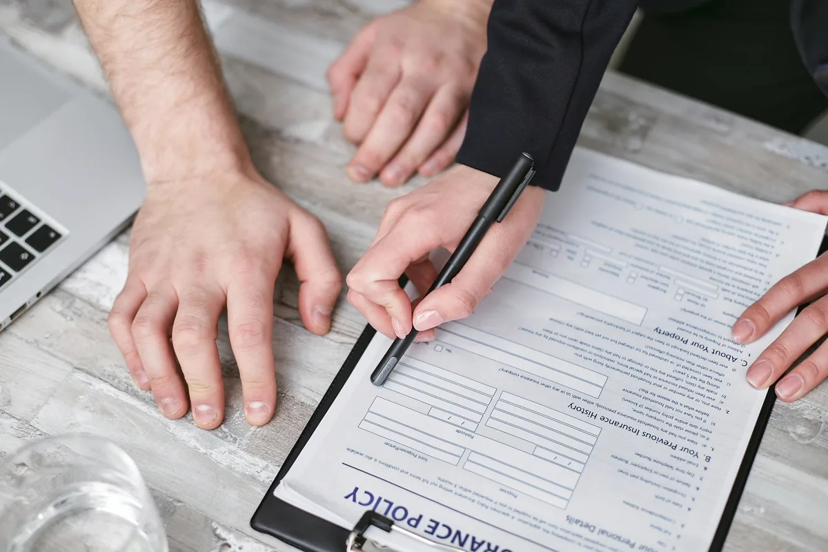 Person signing vehicle insurance policy document