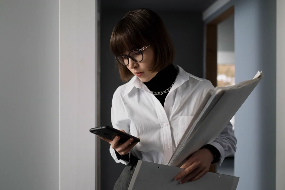 South African woman checking her credit report and debt review status on her phone