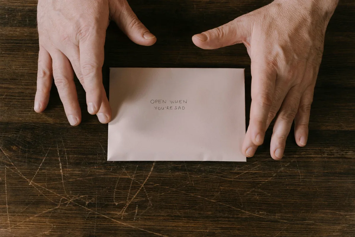 Hands opening a legal letter — Section 129 notice versus letter of demand in South Africa